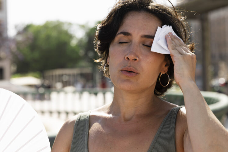 elder-woman-struggling-with-high-temperature-1-748x499